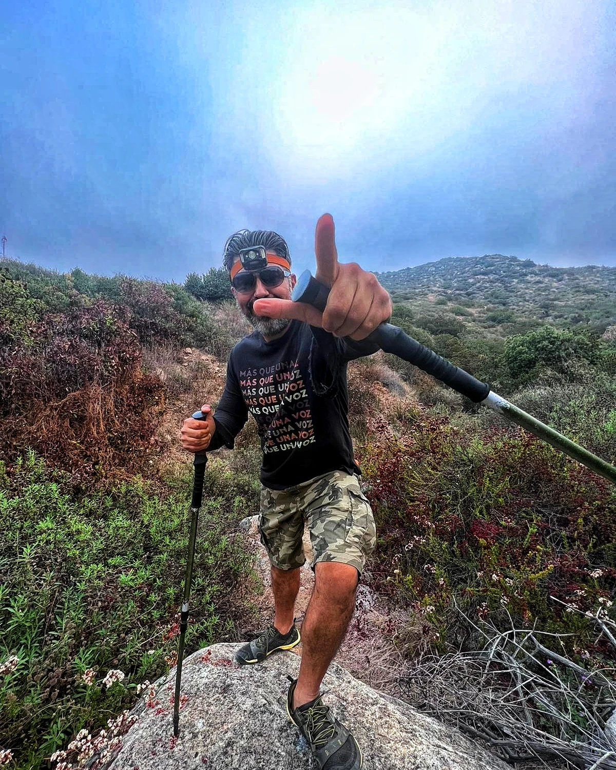 A hiker moving across rugged mountain terrain