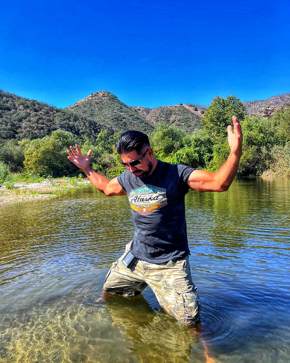 A playful outdoor moment standing in shallow water