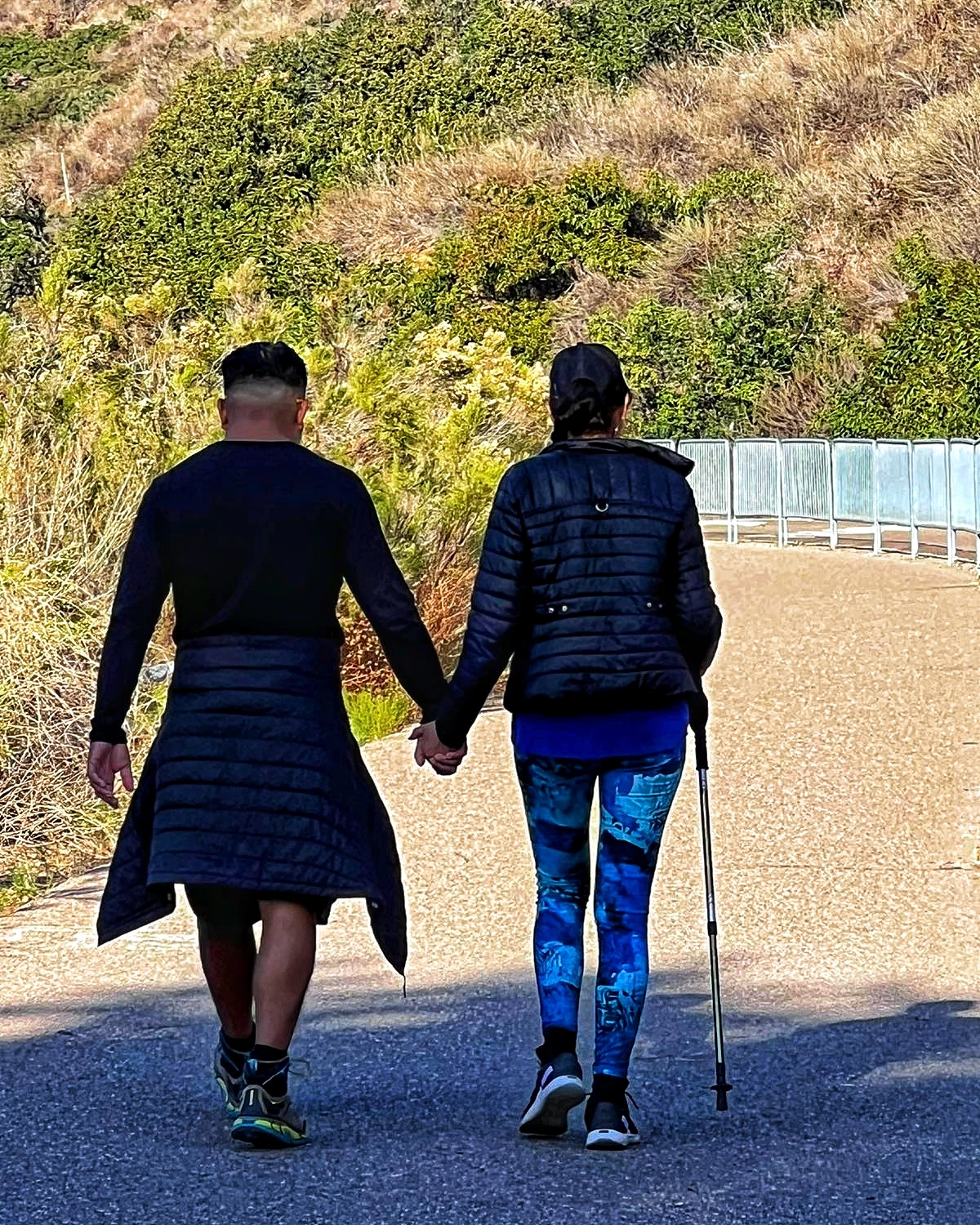 Two hikers walking together along an outdoor path